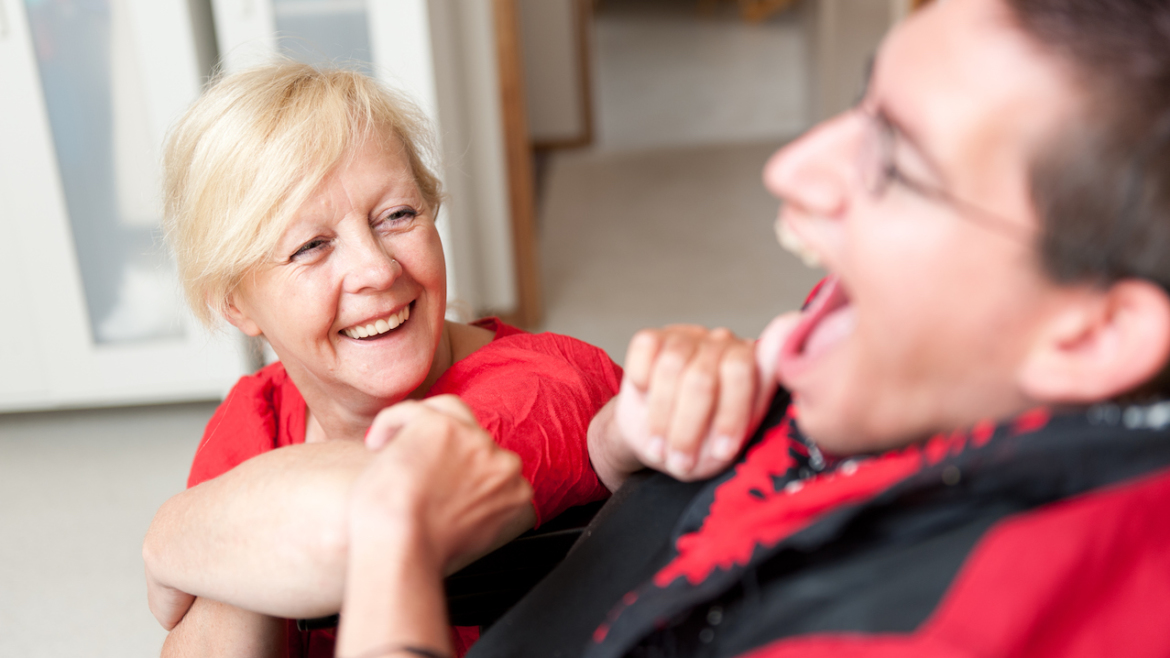 disability support worker looking up at a man
