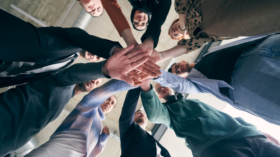 a group of businessmen holding hands together to symbolize unity and strength